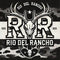Logo of Rio Del Rancho featuring stylized antlers and a skull design with the initials "RDR." The logo is set against a camouflage background and includes the text "Rio Del Rancho" prominently displayed in bold, western-style lettering.